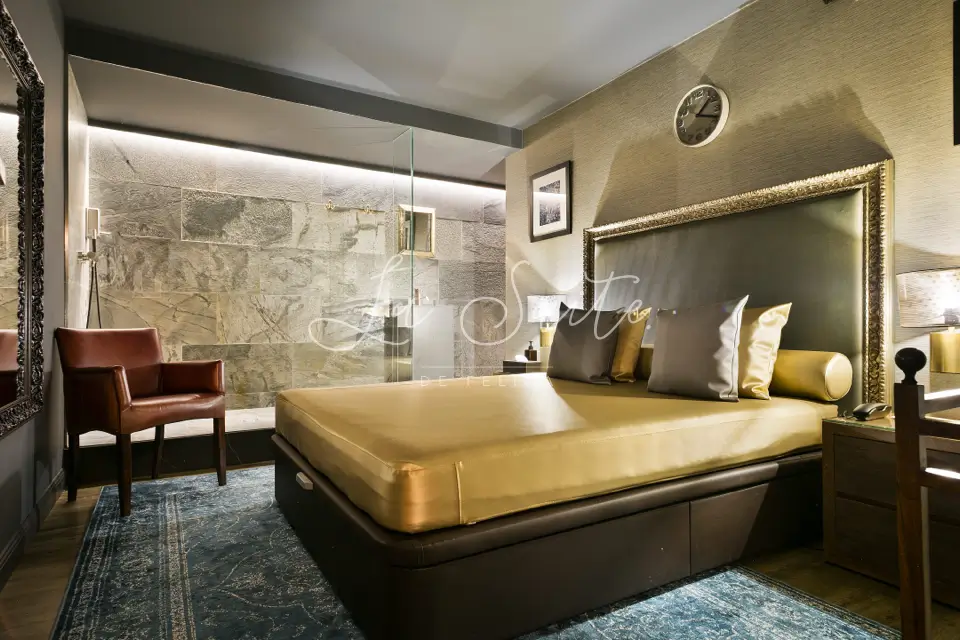 Stylish room, marbled walls and floor, furnished in gold color in La Suite, Barcelona
