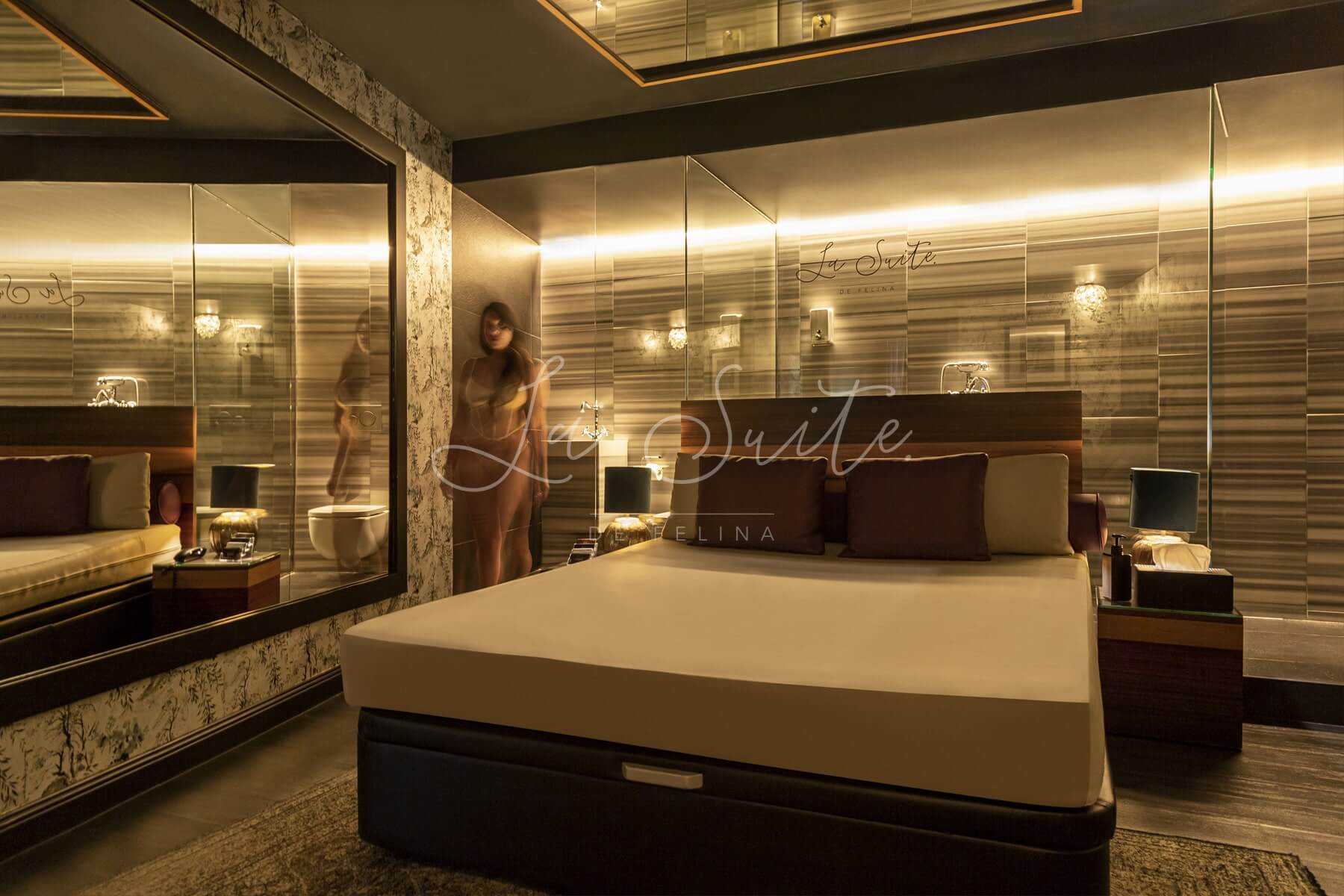 Chambre luxueuse Distinción, avec des murs beiges et noirs, des finitions en bois et un mobilier de luxe dans La Suite, Barcelone
